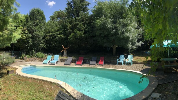 A swimming pool with lounge chairs and a windmill. - COTTAGE IN THE HEART OF THE COUNTRY CATHAR (Fanjeaux)