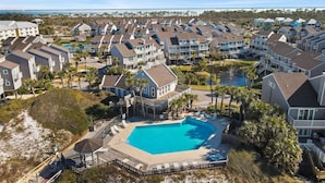 A coastal residential area with a large swimming pool surrounded by houses.