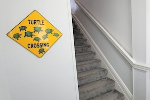 A staircase with a yellow sign indicating a turtle crossing.