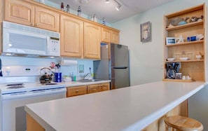 Enjoy cooking in this fully equipped kitchen with a refrigerator, microwave, and kettle.