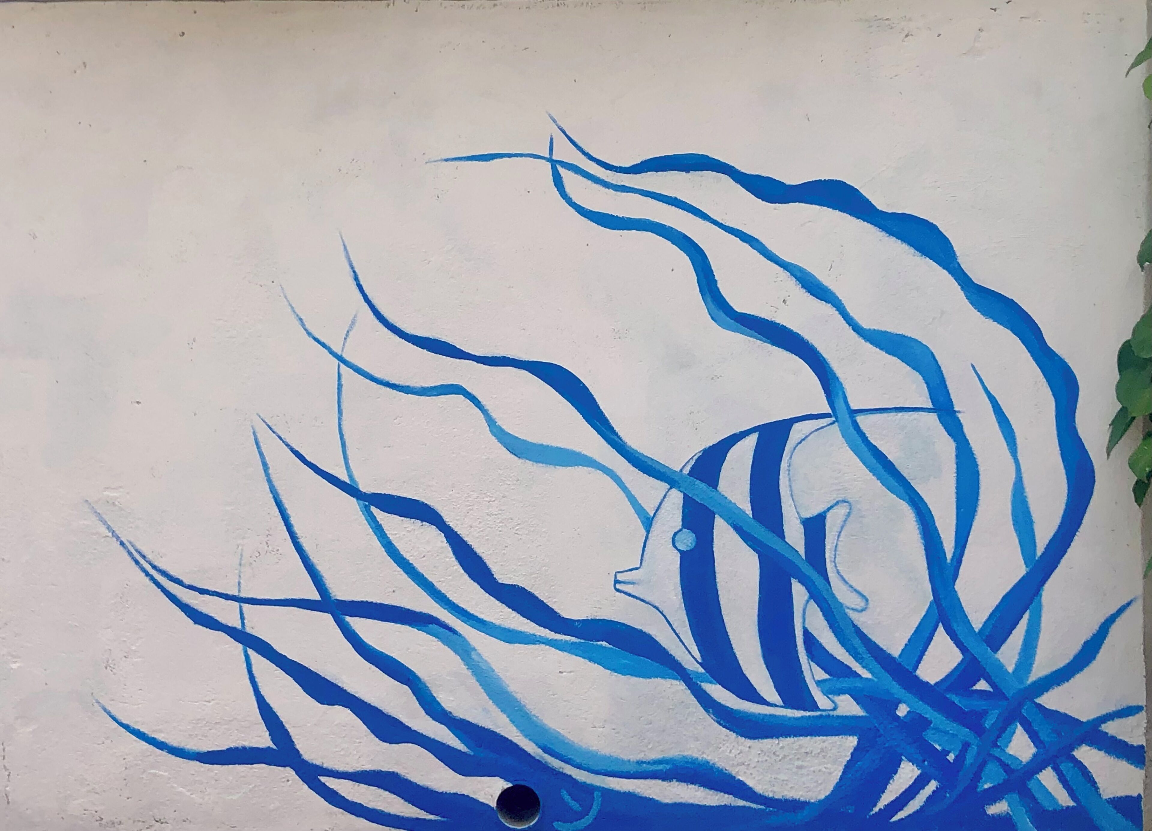 A wall with a blue abstract painting.