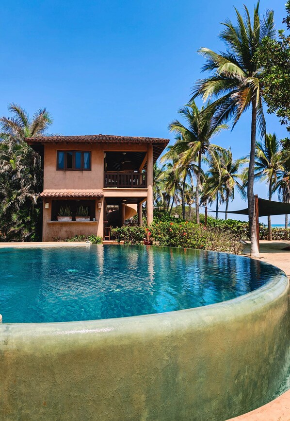 A two-story building with a pool in front.