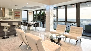 A spacious modern interior with a high ceiling, large windows, and a marble floor. - Pure luxury at #Sunset Wave on the Beach (Treasure Island)