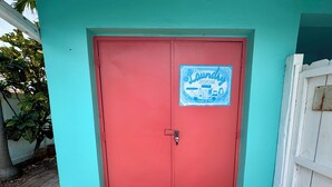 A red door with a sign that reads 'The Laundry Room' and 'Loads of Fun'. - 2-Bedroom Apartment Just A Short Walk To Deerfield Beach Pier (Deerfield Beach)