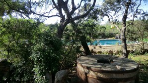 A tree-lined area with a swimming pool in the background. - Son Barbut XVII, Family-friendly (Porreres)