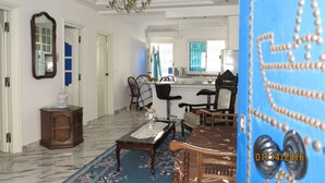 A spacious living room with a marble floor, a chandelier, and a dining area with a blue tablecloth. - Holiday rentals: Charming house between sea and mountain, (RAFRAF)