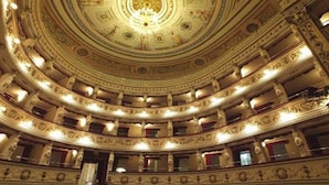 A grand, ornate theater with multiple balconies and a richly decorated ceiling.