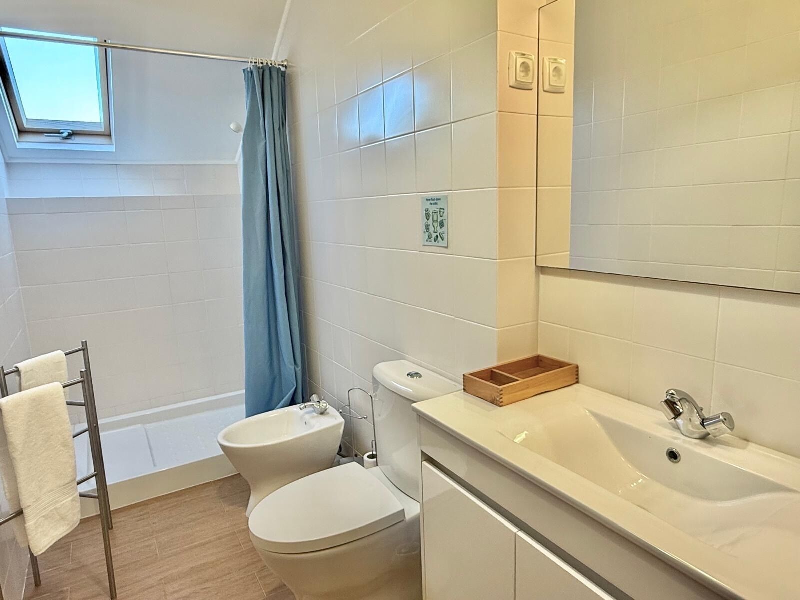 A bathroom with a toilet, bidet, and sink.