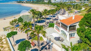 A coastal hotel with a beach view, outdoor seating, and a pool area. - Beachfront apartment perfect for families - UHC GLADIOLS 211 (Cambrils)
