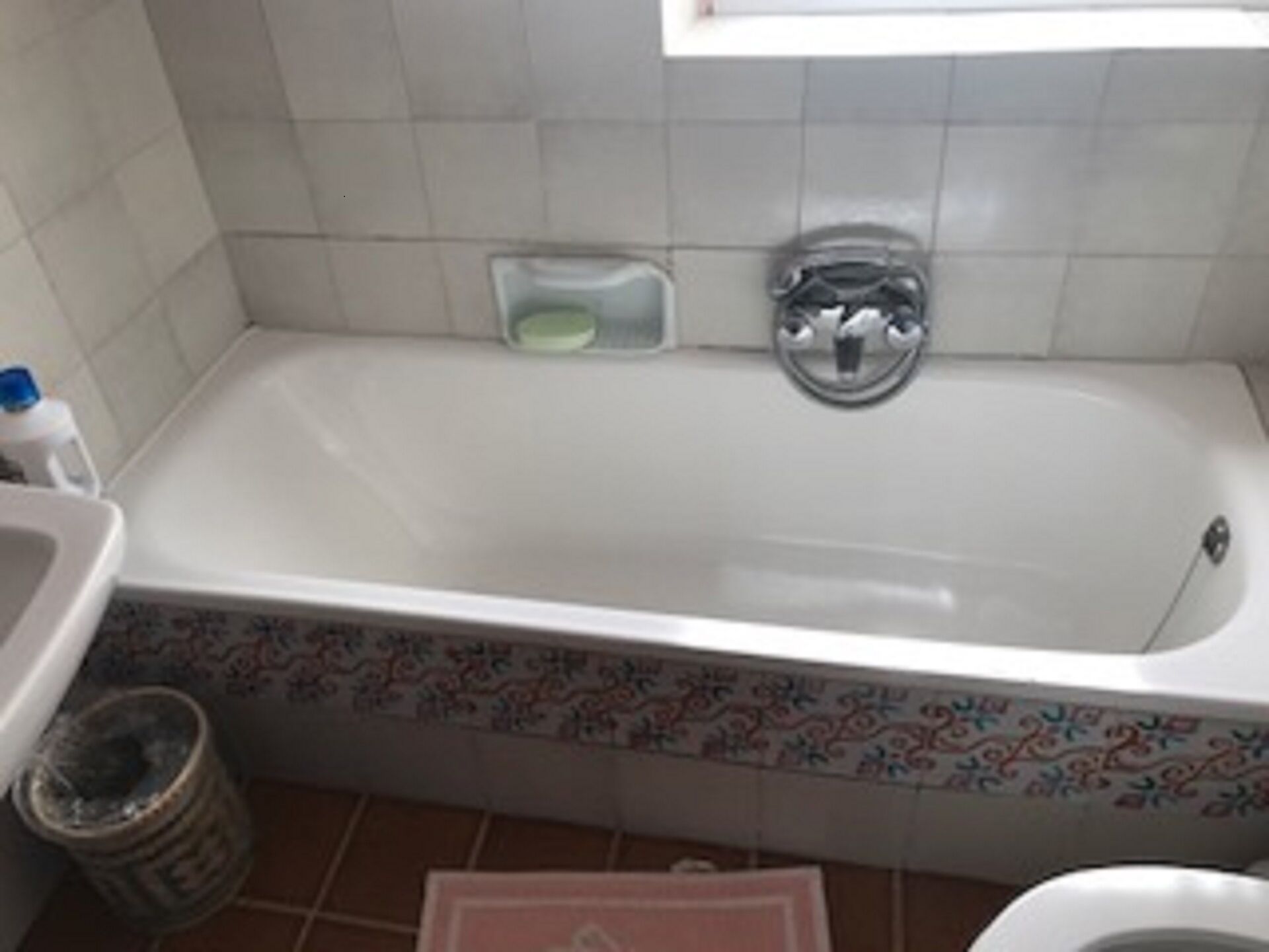 A bathroom with a bathtub, a toilet, and a sink.