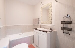Bathtub, towels, soap, toilet paper