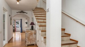 A staircase with wooden steps and a white wall.