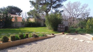 A garden with a gravel path, trimmed hedges, and a small pond. - Paradou quiet house with pool and garden near Les Baux de Provence (Paradou)