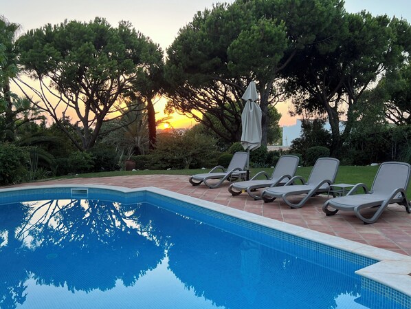 Outdoor pool, a heated pool, sun loungers