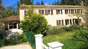 A two-story building with a tiled roof, multiple windows with shutters, and a surrounding garden. - 100% quiet in Uzès! Swimming-pool 12X8m, 60m²+private terrace, big garden, WIFI  (Uzès)