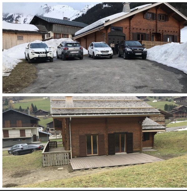 A rustic chalet with a wooden exterior, a covered porch, and a view of snow-capped mountains.