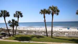 A beach view with palm trees, a sandy beach, and the ocean. - El Matador 428 - FREE TICKETS!! Your stay includes free tickets to many area attractions! (Fort Walton Beach)