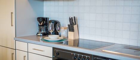 Fridge, stovetop, dishwasher, coffee/tea maker