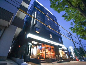 A modern hotel building with a prominent entrance, large windows, and a visible sign reading "HOTEL GYEMAX". - Hotel Livemax, Hashima Ekimae (Hashima)