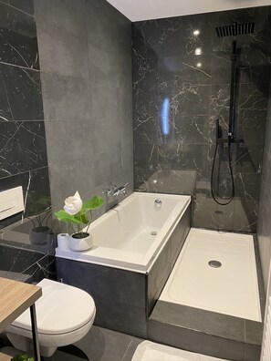 Bathtub, towels, soap, toilet paper