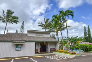 A building with a sign reading "Makai Club" and a small porch with benches. - Free-Standing Cottages On North Shore Kauai! ~ 5 Minute Drive to Hanalei Bay ~ (Princeville)