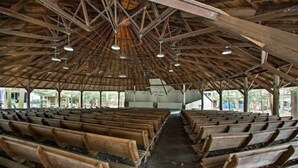 A large, open hall with rows of wooden benches and a high, wooden ceiling with exposed beams and hanging lights. - ​Park & Walk: Gretna Lake, Trails & Attractions (Mount Gretna)