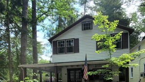 A two-story house with a porch, a small garden, and an American flag. - ​Park & Walk: Gretna Lake, Trails & Attractions (Mount Gretna)