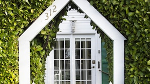A white picket fence with the number 312 on it, leading to a white door with a window. - SEQUIM HERITAGE HOUSE where relaxed elegance & craftsmanship abound....  (Sequim)