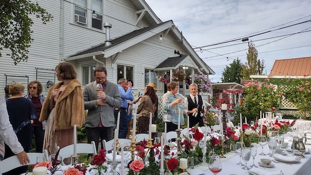 An outdoor dining area with tables set for a formal event, surrounded by a house and garden. - SEQUIM HERITAGE HOUSE where relaxed elegance & craftsmanship abound....  (Sequim)