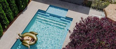 A heated pool, pool loungers