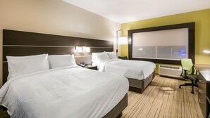 A hotel room with two beds, a desk, a chair, and a large window with a view.