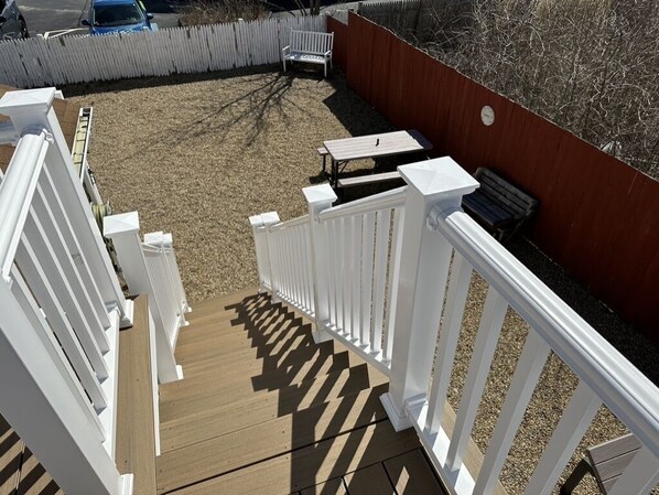 A deck with white railings, a wooden floor, and a red wall. - "A COZY PLACE AT FIELDSTONE BEACH" (marshfield)