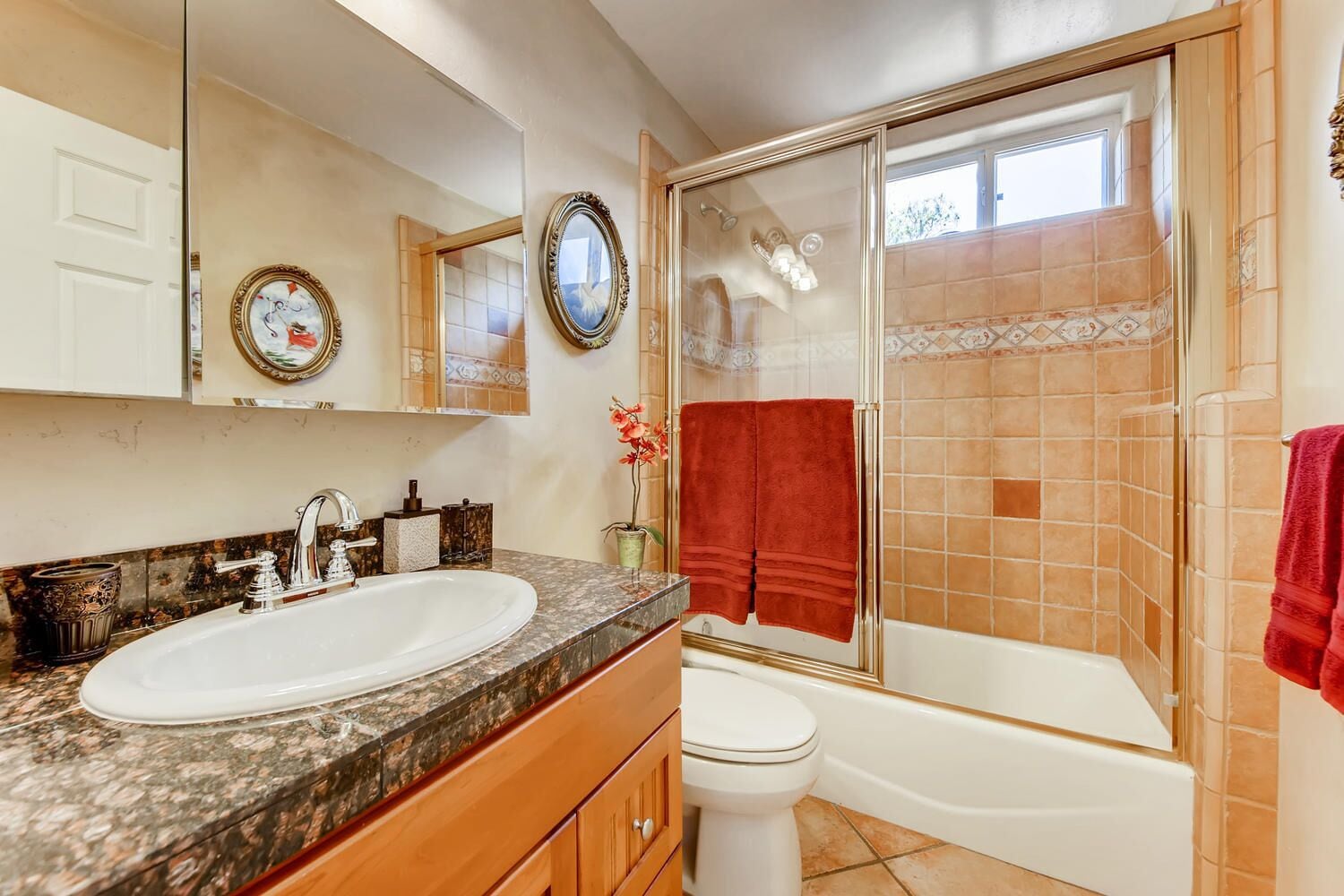 A bathroom with a double sink, a toilet, and a bathtub.
