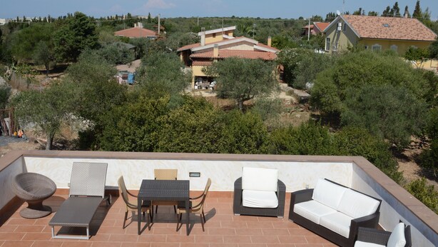 A rooftop terrace with outdoor furniture, a view of the surrounding area, and a clear sky. - Villaial, recent, with swimming pool, surrounded by greenery among olive trees (San Giovanni)