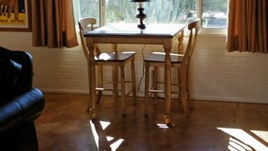 A dining area with a table and chairs, a lamp, and a window with curtains. - Foothills Ranch House in Casas Adobes, 8 ac estate with Pool, Tennis, Pickleball (Tucson)