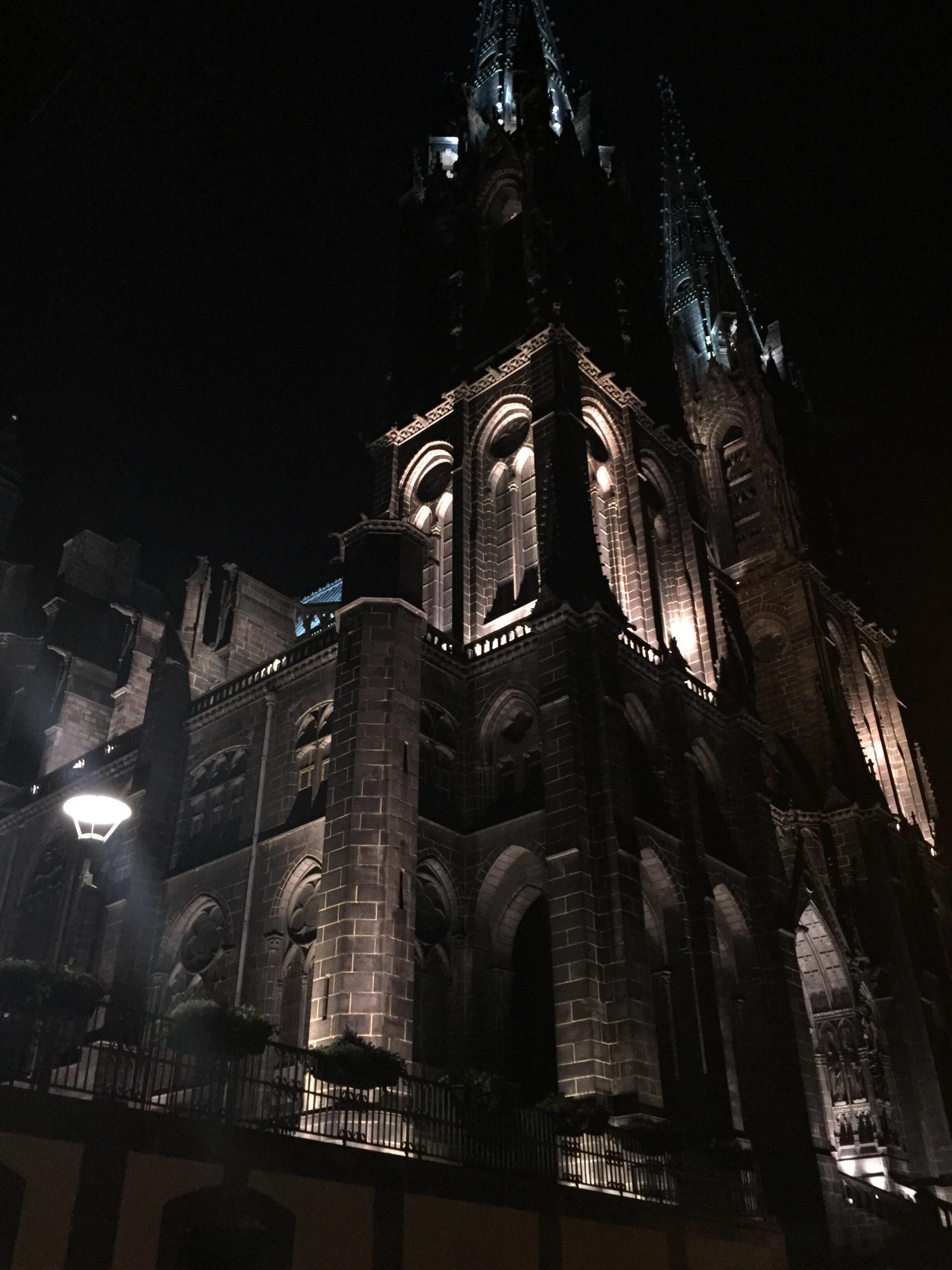 A large, illuminated cathedral with intricate architecture and a prominent spire.