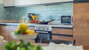 A modern kitchen with a built-in oven, a microwave, and a coffee maker. - Villa Rosa - Private villa, 5 bedrooms, pool, A/C, wifi, pets, Marche (Fossombrone)