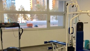 A gym with a treadmill, weight machines, and benches. - BEAUTIFUL MEDITERRANEAN AVENUE APARTMENT (Benidorm)