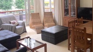 A living room with a sofa, chairs, a coffee table, a TV, and a cabinet. - BEAUTIFUL MEDITERRANEAN AVENUE APARTMENT (Benidorm)