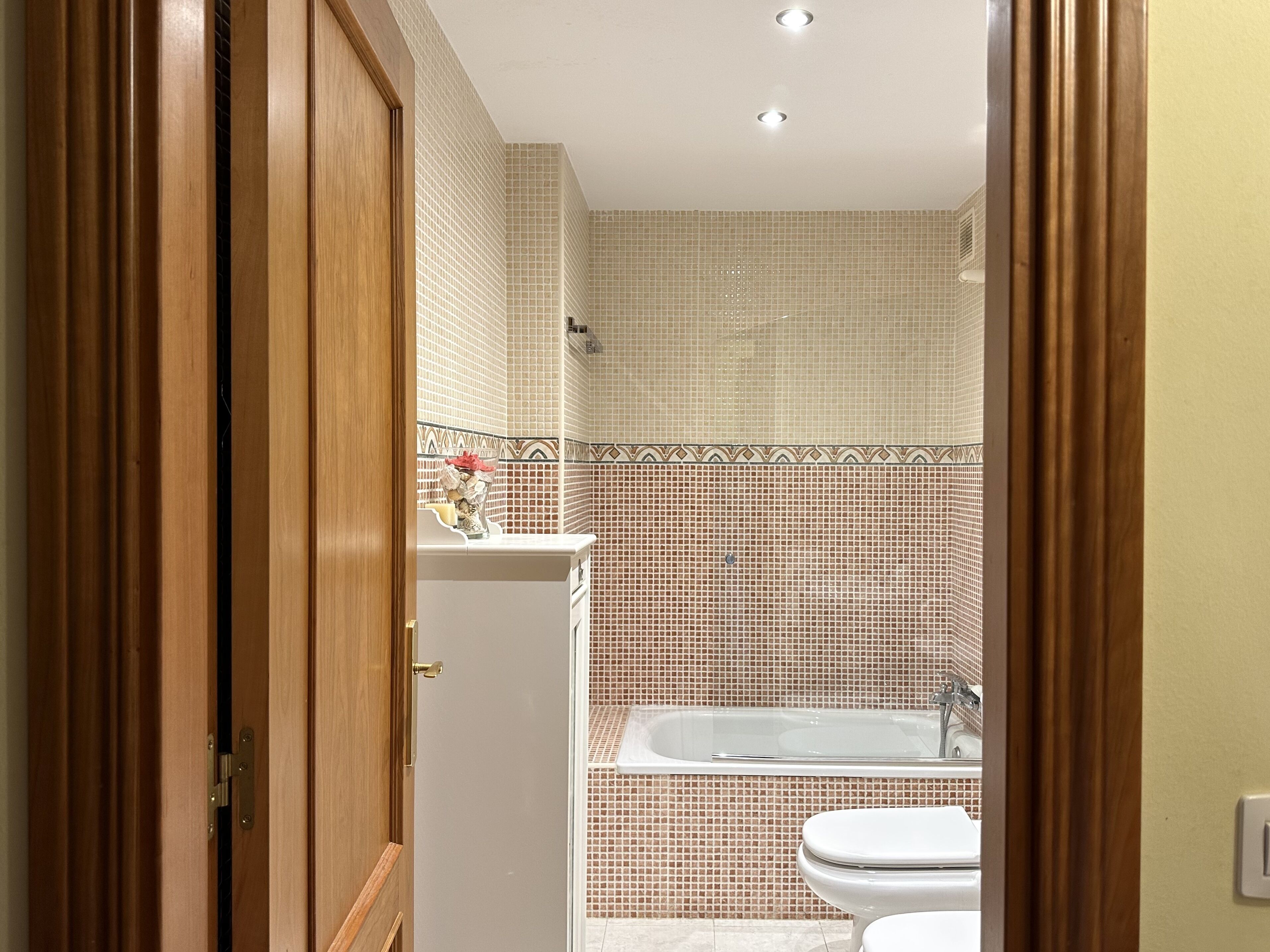 A bathroom with a bathtub, toilet, and sink.