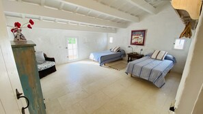 A spacious bedroom with two single beds, a sofa, a dresser, and a painting on the wall. - Magnificent country house with private pool, free WiFi (Sant Climent)