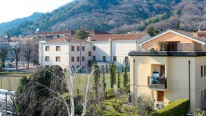 Un quartier résidentiel avec des immeubles à plusieurs étages, un paysage montagneux en toile de fond et un ciel dégagé.