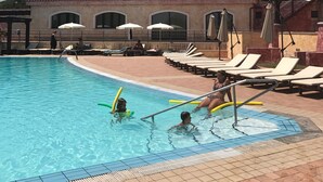 A swimming pool area with lounge chairs and umbrellas. - Very panoramic 10 minutes walk from the sea (Villaputzu)