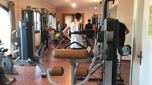 A gym with various exercise machines, a wooden floor, and a mirror on the wall. - Very panoramic 10 minutes walk from the sea (Villaputzu)