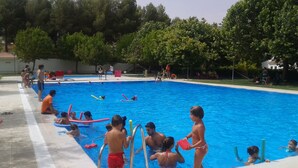 A swimming pool with people engaging in various activities. - Residential tourist use with WiFi (Villarcayo)