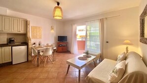 A compact living space with a kitchenette, dining area, and a sofa. - Playa San Juan, 2 room apartment close to the beach me WiFi (Playa San Juan)