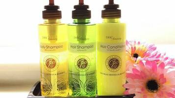 Three bottles of DHc Amity hair products on a display.