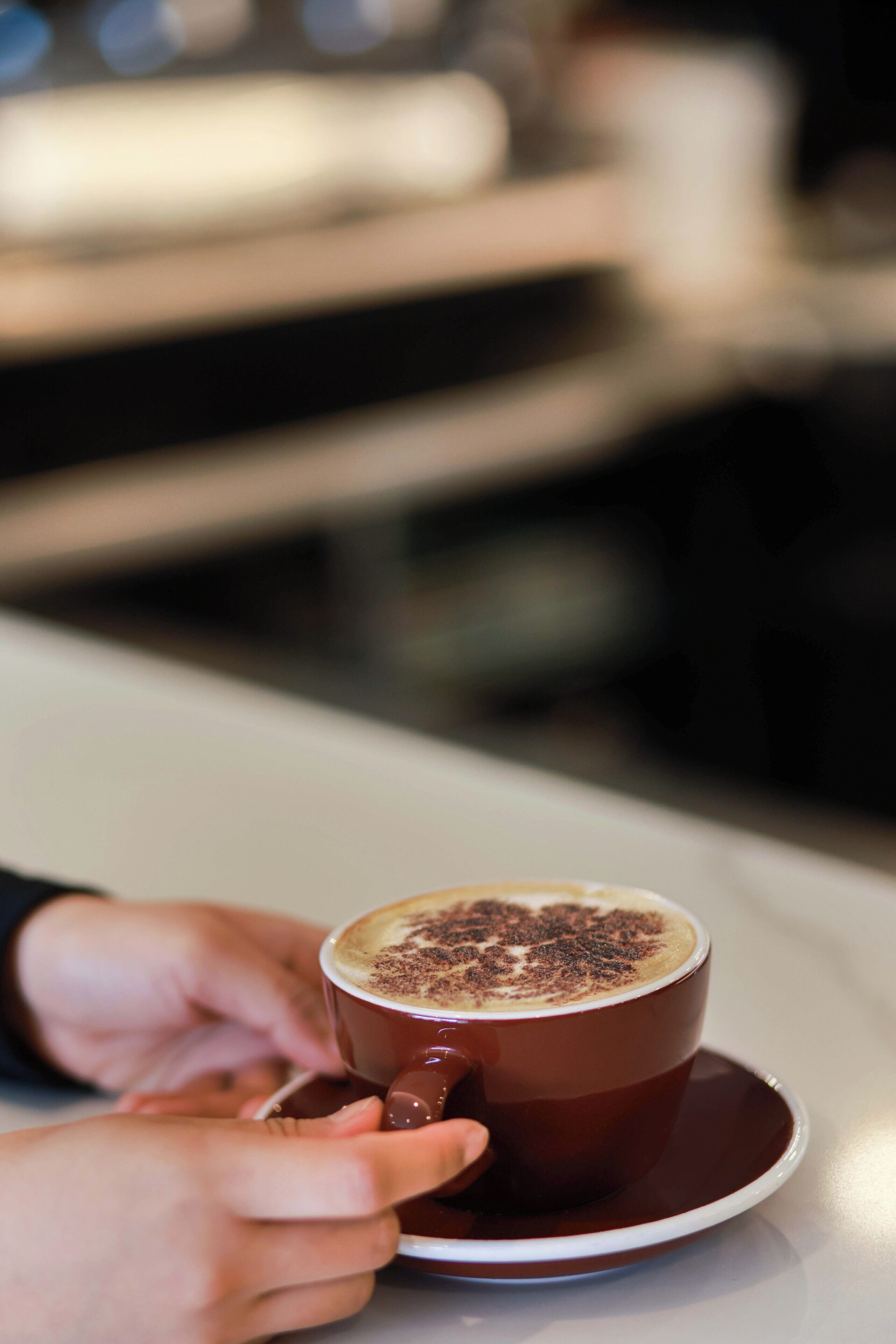 Uma chávena de café com espuma num pires.