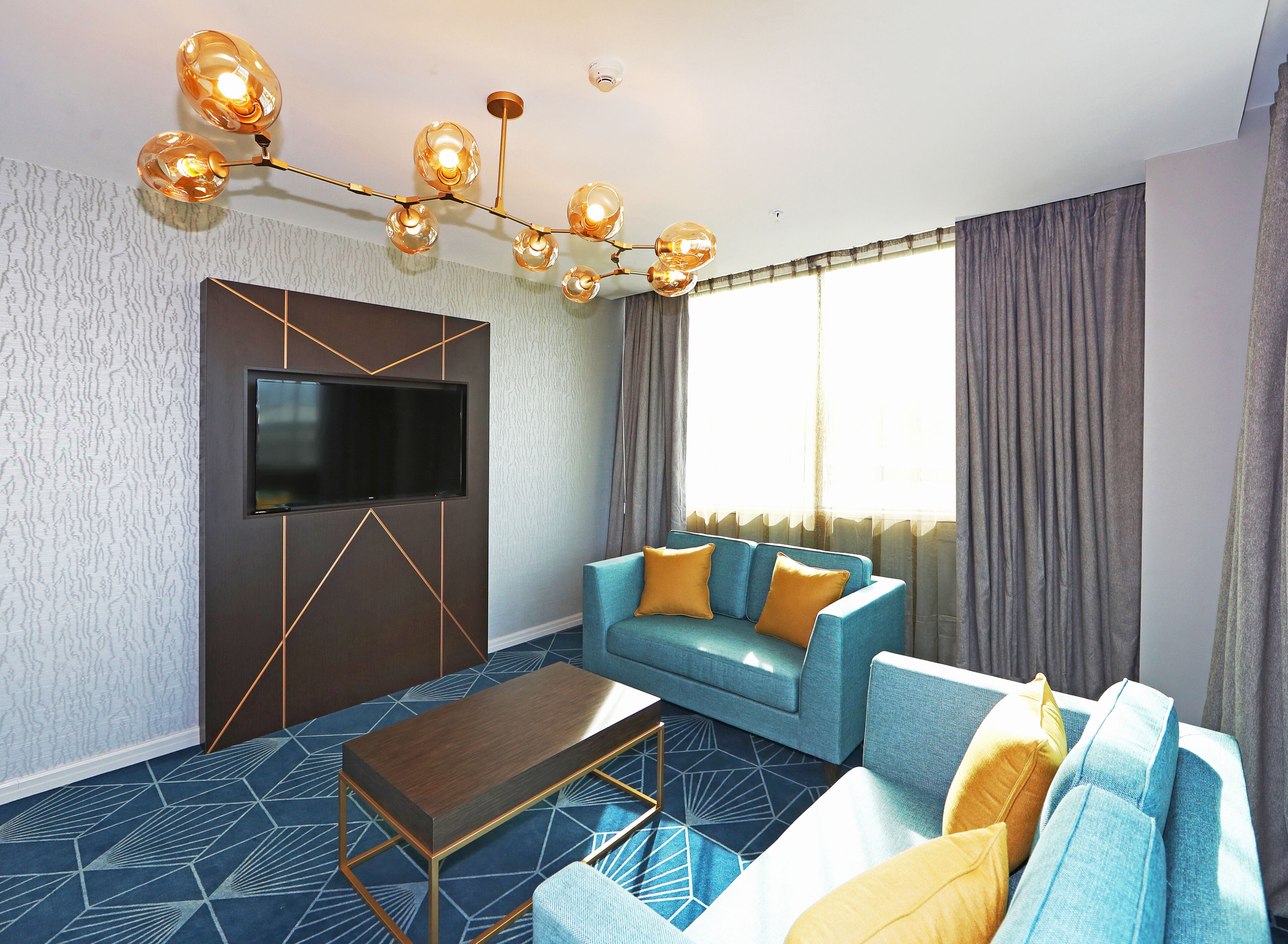 swiss-supersuite two bedroom | living area | flat-screen tv