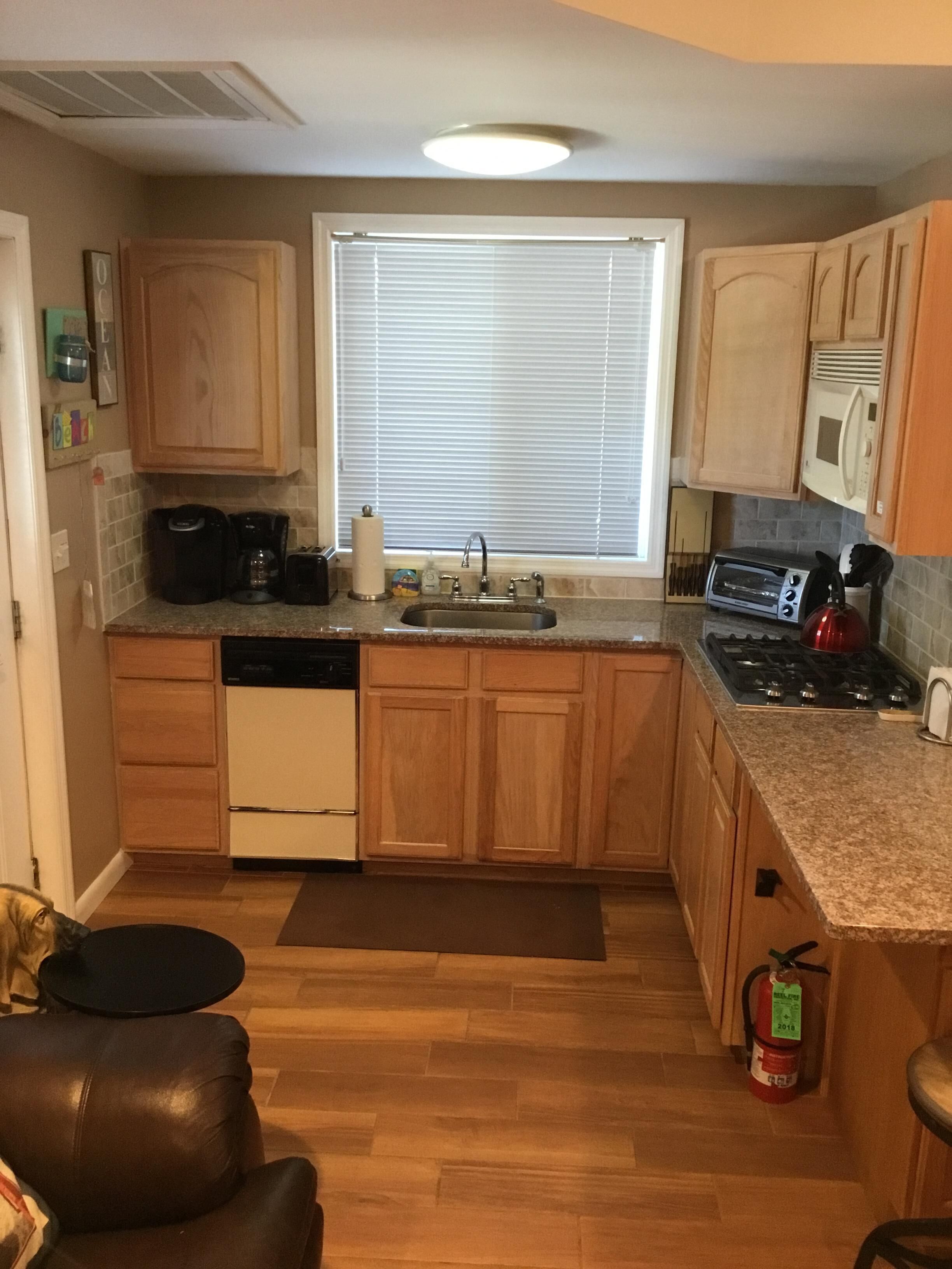 ENJOY YOUR FAVORITE BEVERAGE FEELING THE OCEAN BREEZE ON THE LARGE PORCH